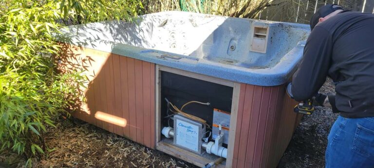 man-unscrewing-a-hot-tub-component-with-a-drill